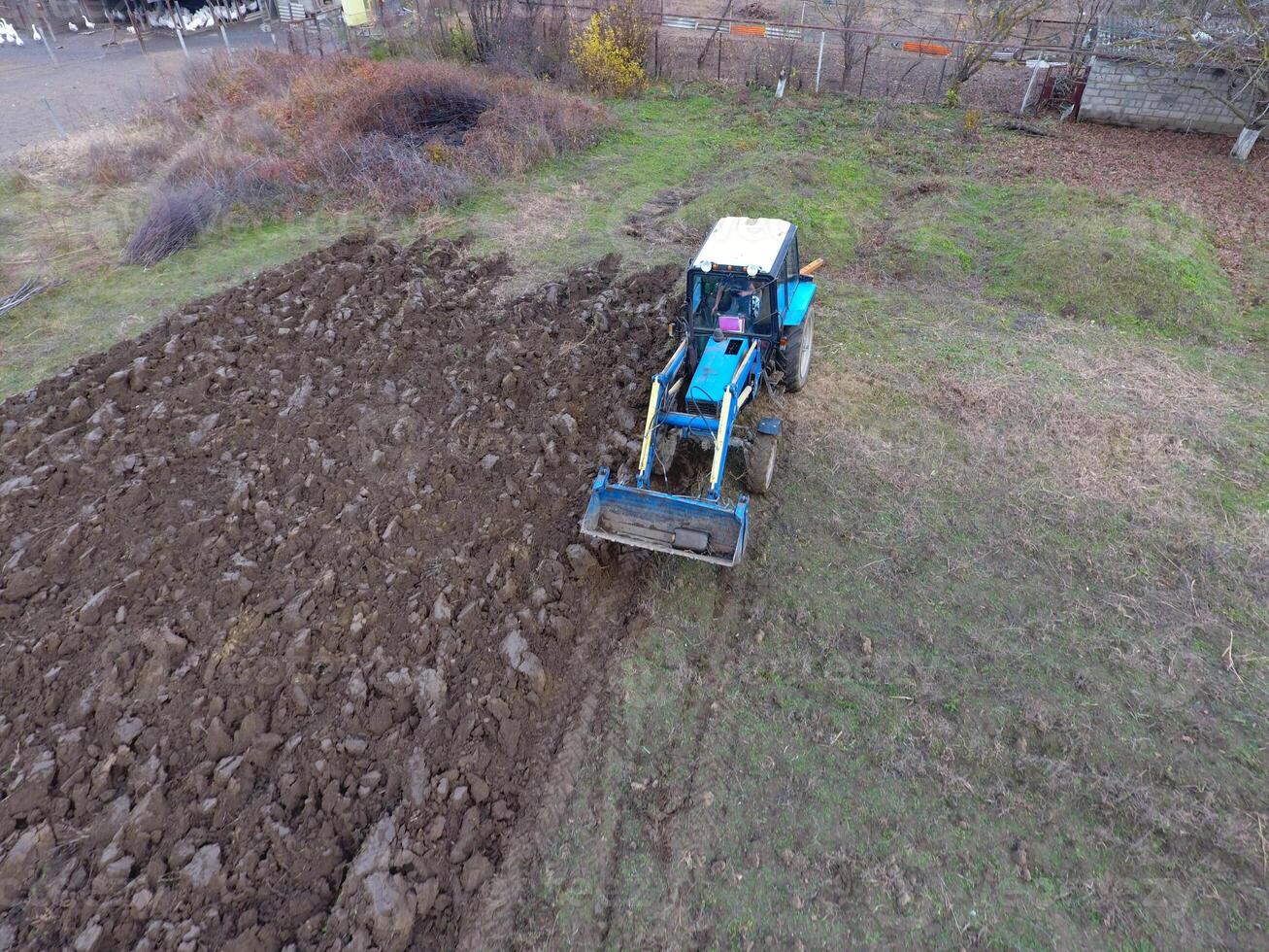 Tractor plowing the garden. Plowing the soil in the garden photo