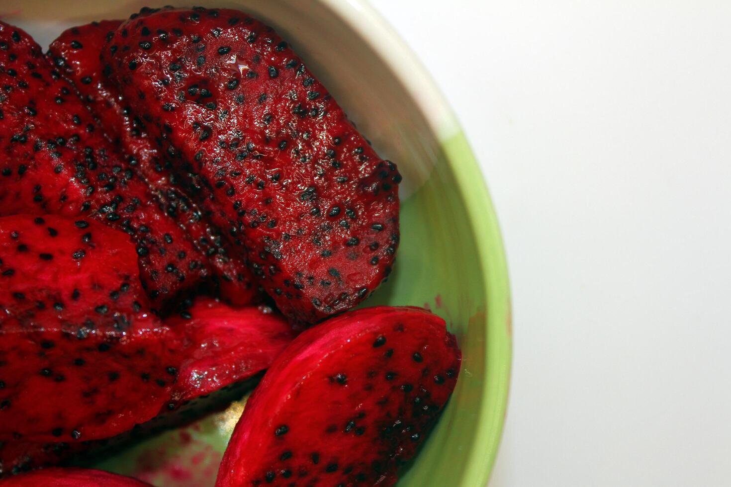 Pitaya and pitahaya in a bowl on white background photo