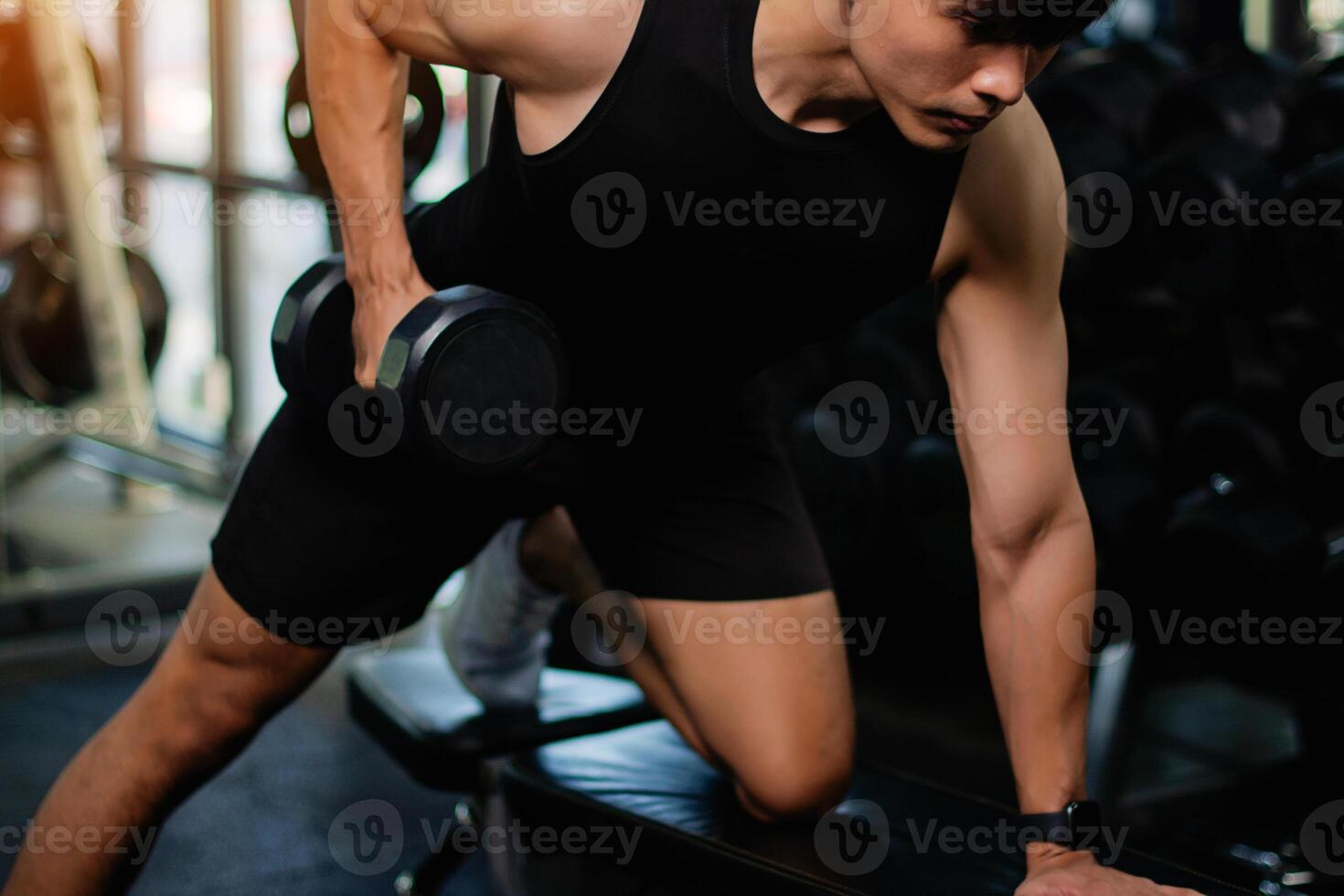 Lifting dumbbell exercises builds strong upper arm muscles. Exercise activities for health lovers and builds a good and strong figure. photo