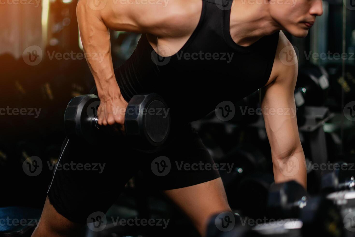Lifting dumbbell exercises builds strong upper arm muscles. Exercise activities for health lovers and builds a good and strong figure. photo