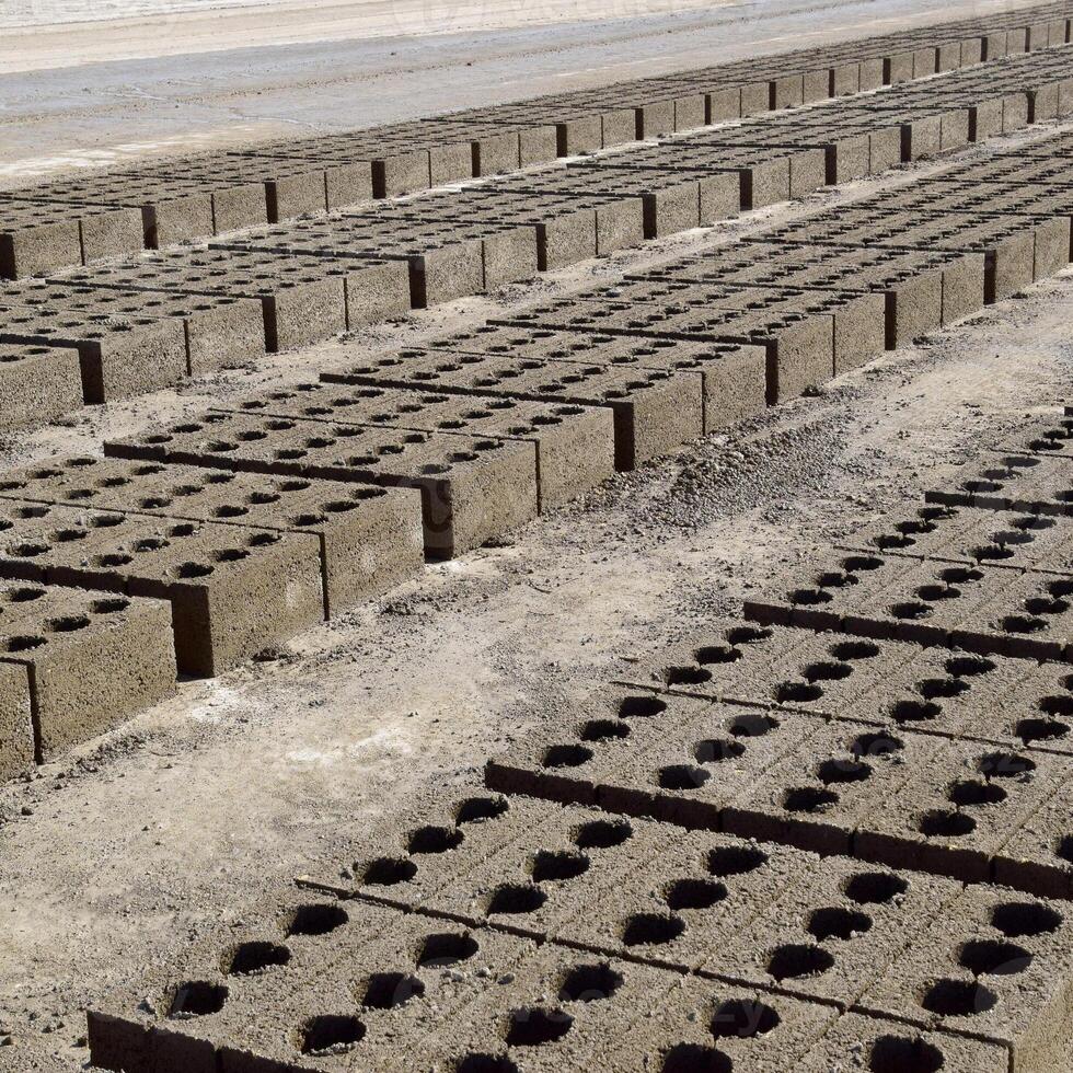 Cinder blocks lie on the ground and dried. on cinder block production plant. photo