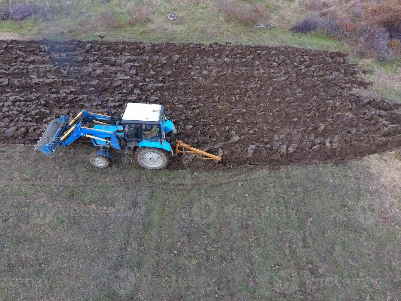 Tractor plowing the garden. Plowing the soil in the garden photo