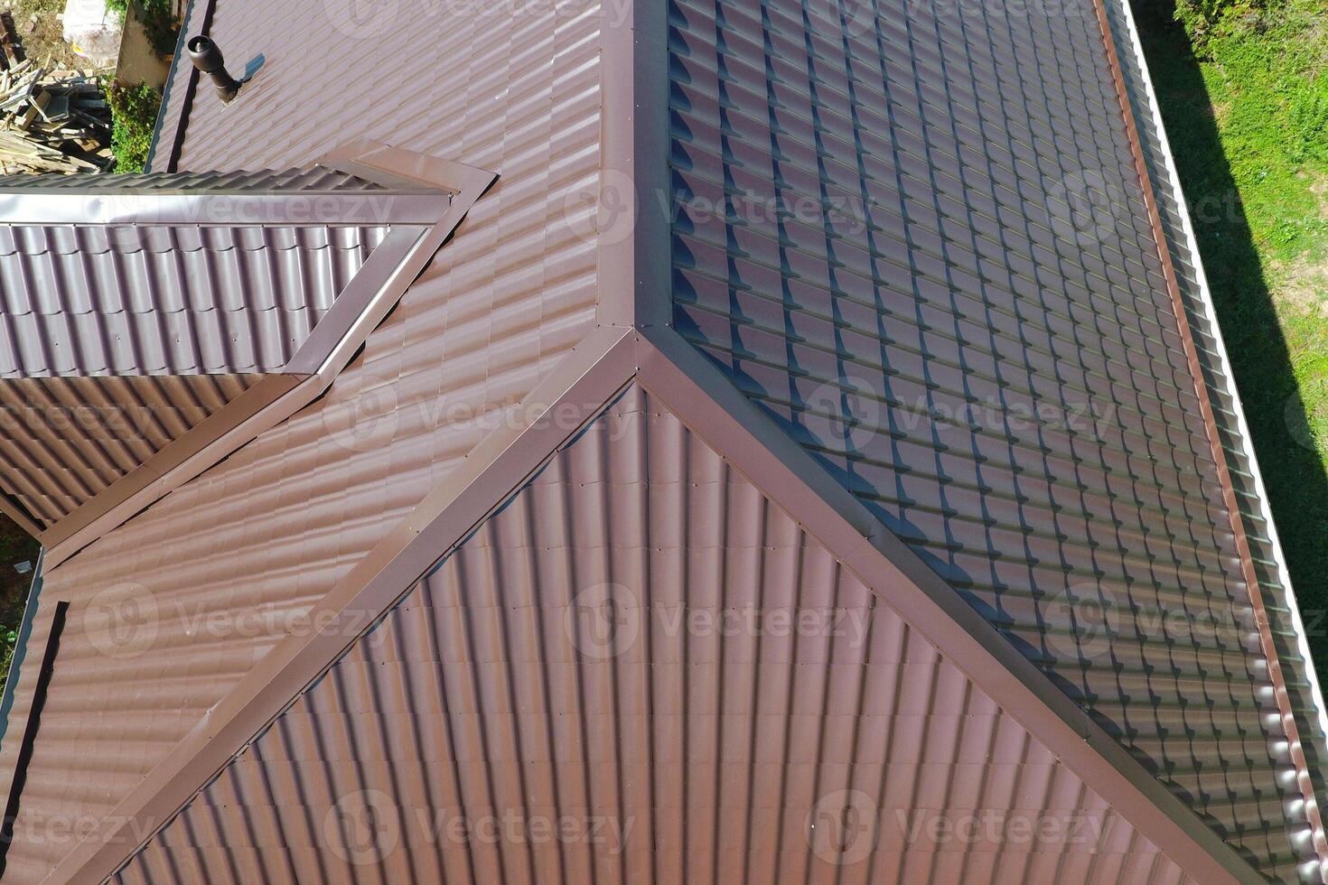 A view from above on the roof of the house. The roof of corrugated sheet. Roofing of metal profile wavy shape photo