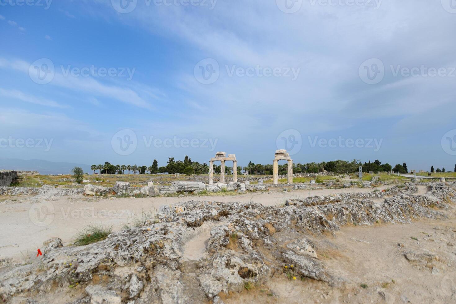 Elements of antique ruins of limestone blocks. The destroyed columns. Ruins of city of Hierapolis photo