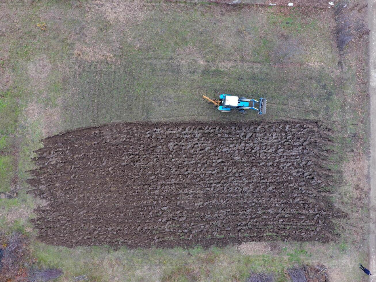 Tractor plowing the garden. Plowing the soil in the garden photo