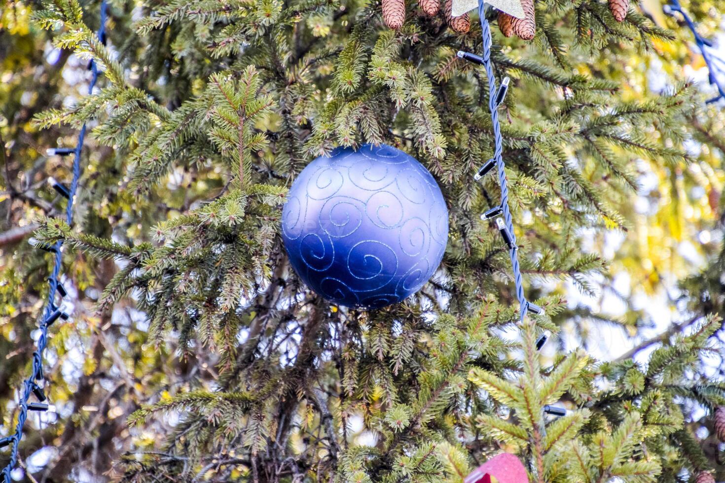 Decorations New Year tree. Tinsel and toys, balls and other decorations on the Christmas Christmas tree standing in the open air. photo