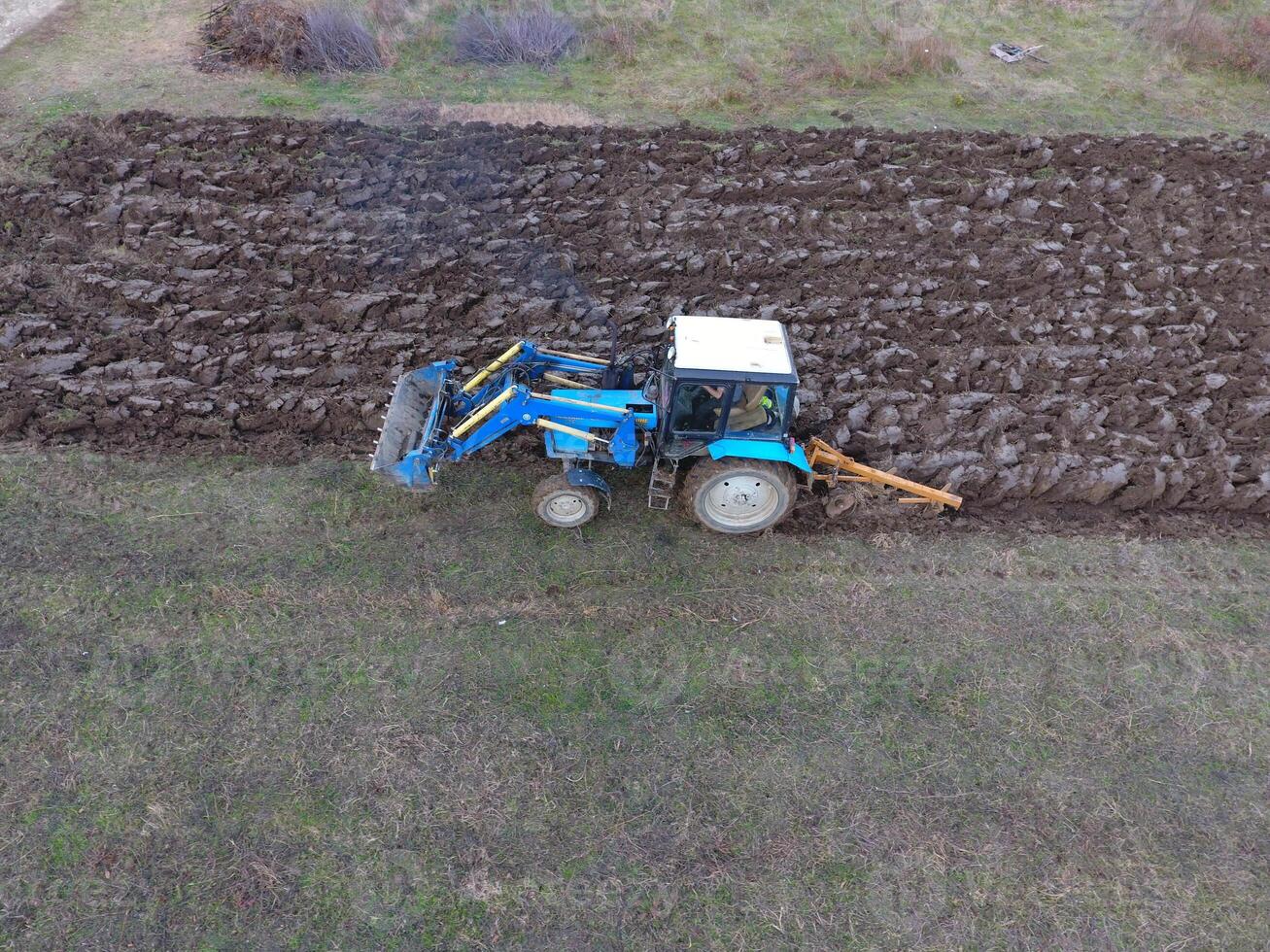 Tractor plowing the garden. Plowing the soil in the garden photo