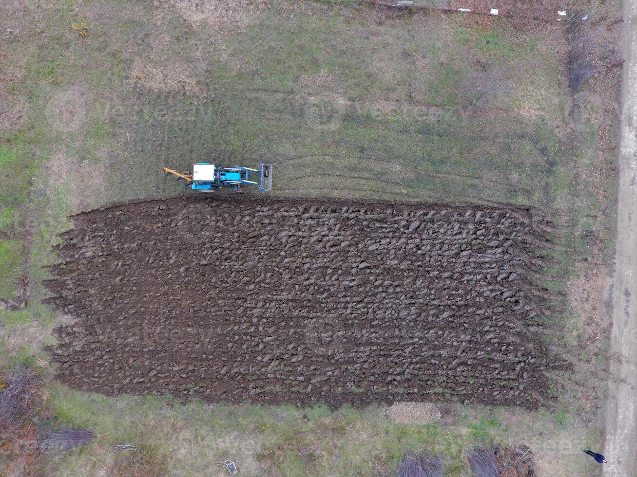 Tractor plowing the garden. Plowing the soil in the garden photo