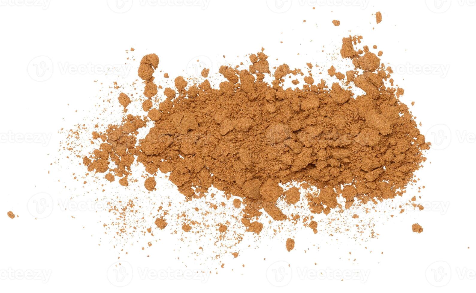 Scattered crushed cinnamon on an isolated background. photo