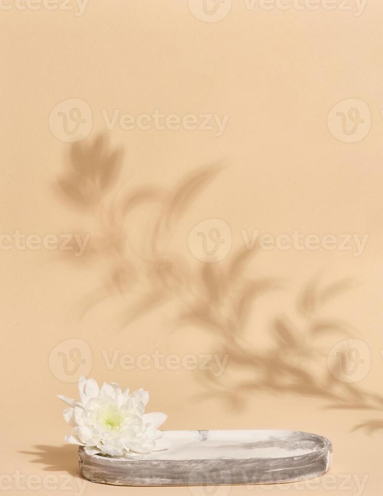 Empty round white marble stand on a beige background photo