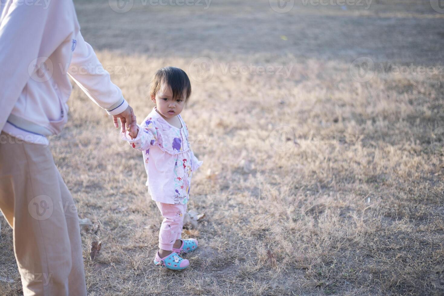 Mother and daughter playing and running around the park on beautiful morning. photo