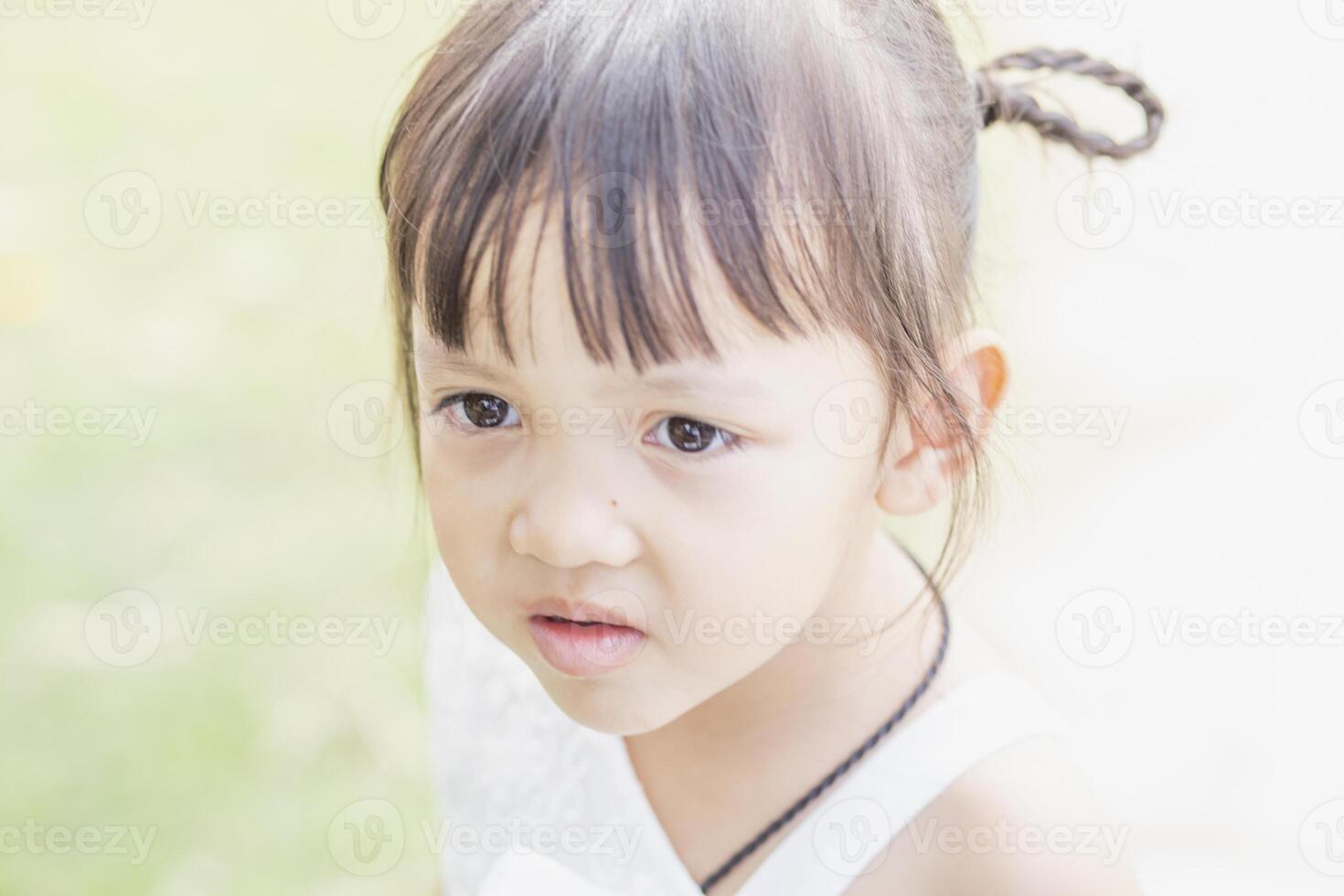 A happy young girl admires and gently touches and admires a blooming flower. It reflects the beauty of spring and the simple pleasures of being in contact with nature. Spring awakening. photo