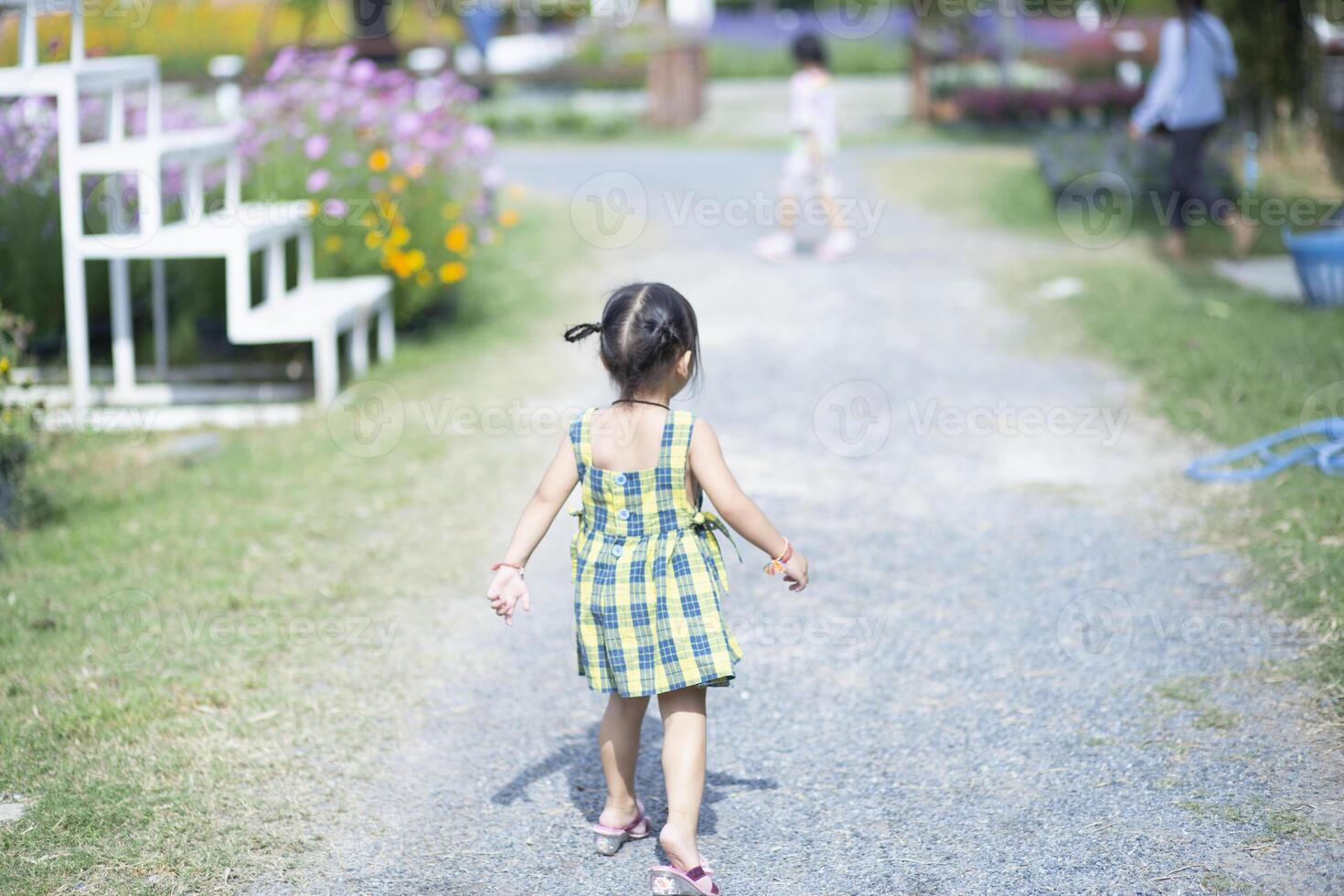 beatiful woman asia style on yellow flower garden and looking smile happy time on the day photo