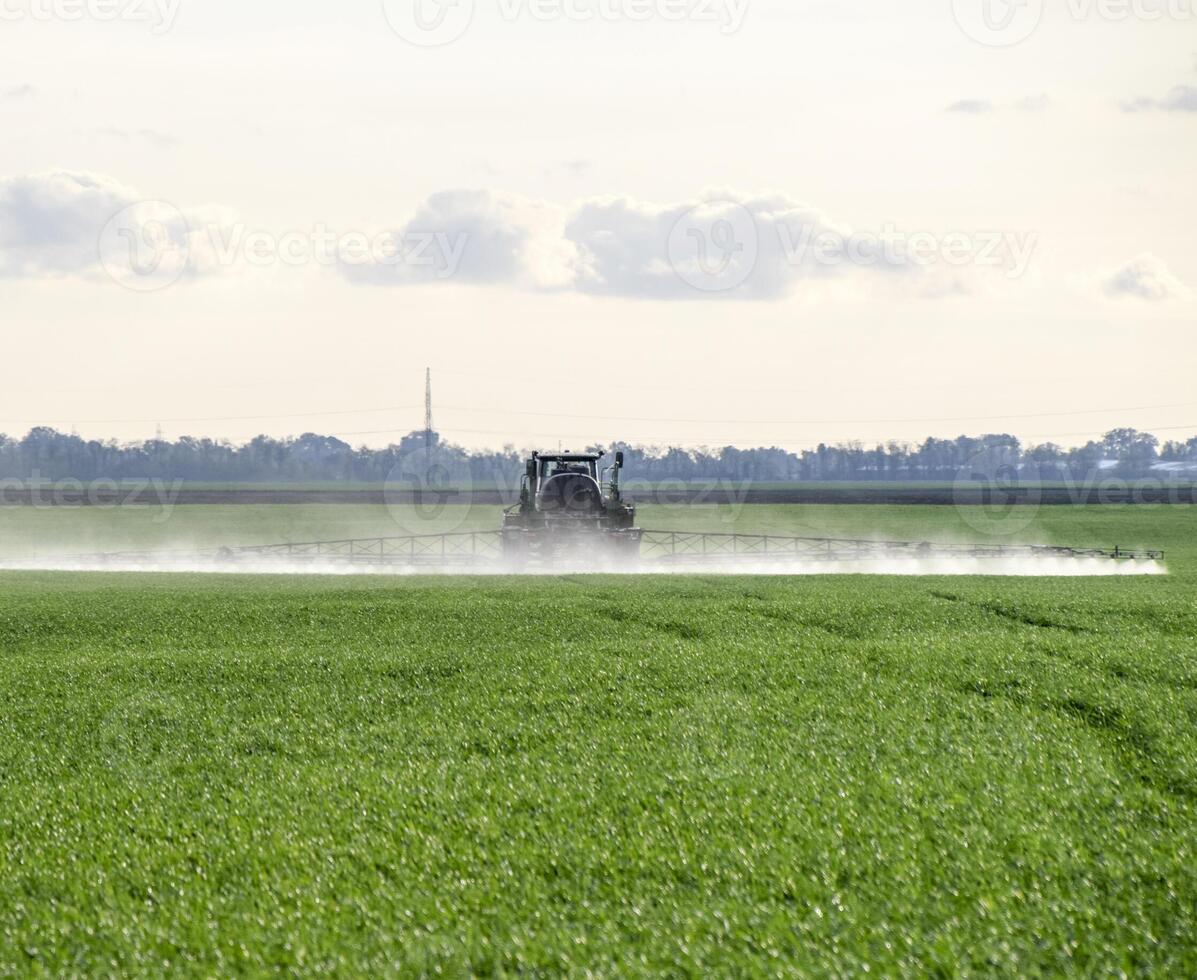 Tractor with a spray device for finely dispersed fertilizer. photo