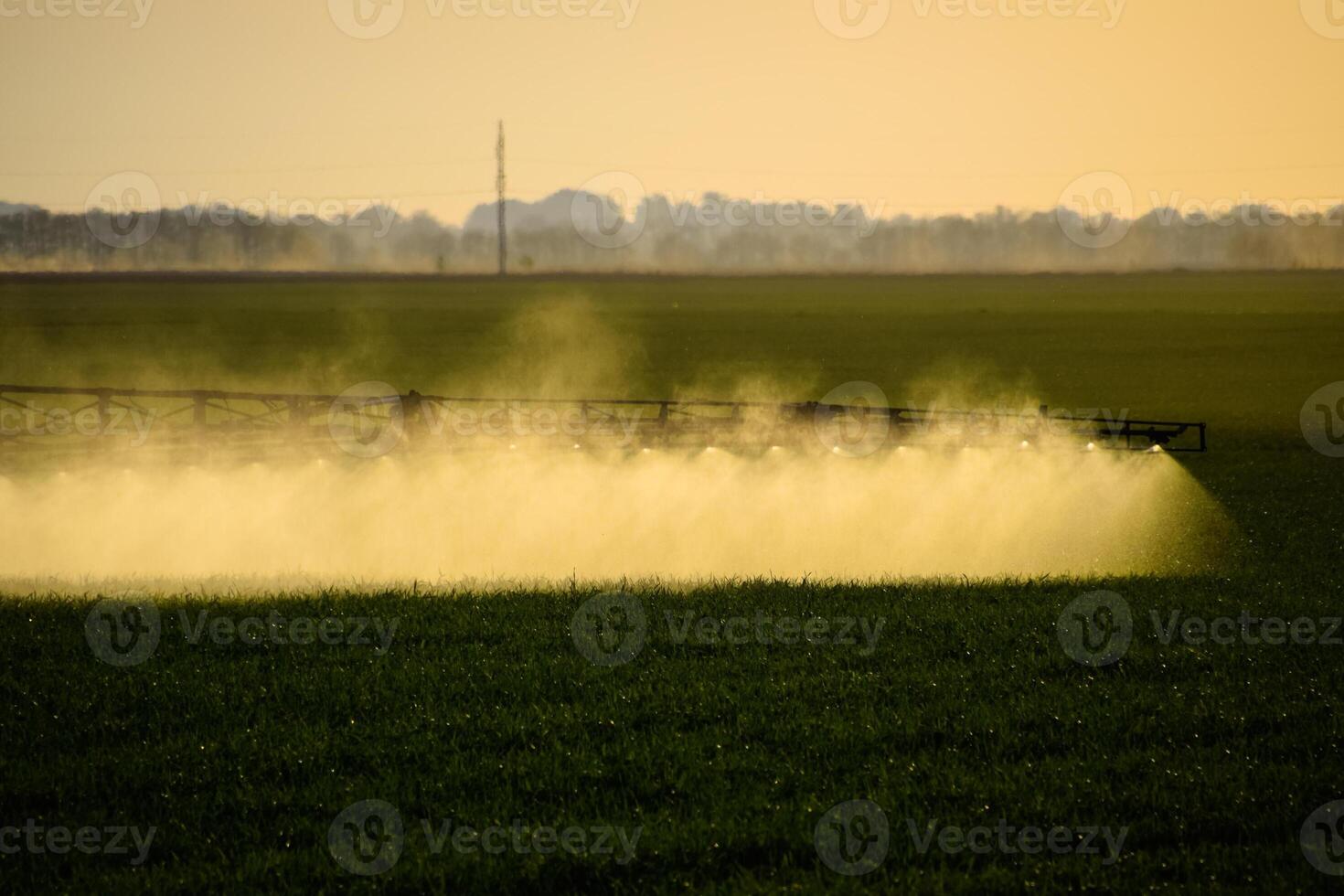 Jets of liquid fertilizer from the tractor sprayer. photo