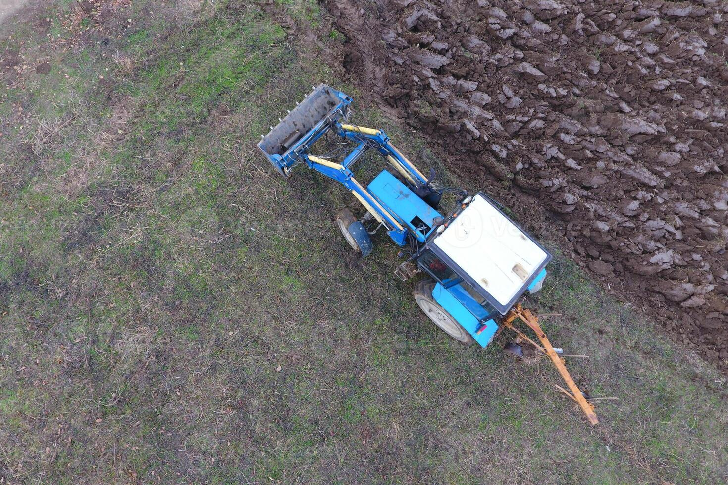 Tractor plowing the garden. Plowing the soil in the garden photo