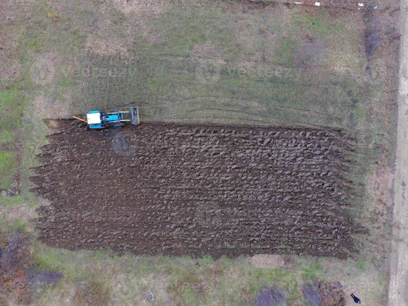 Tractor plowing the garden. Plowing the soil in the garden photo