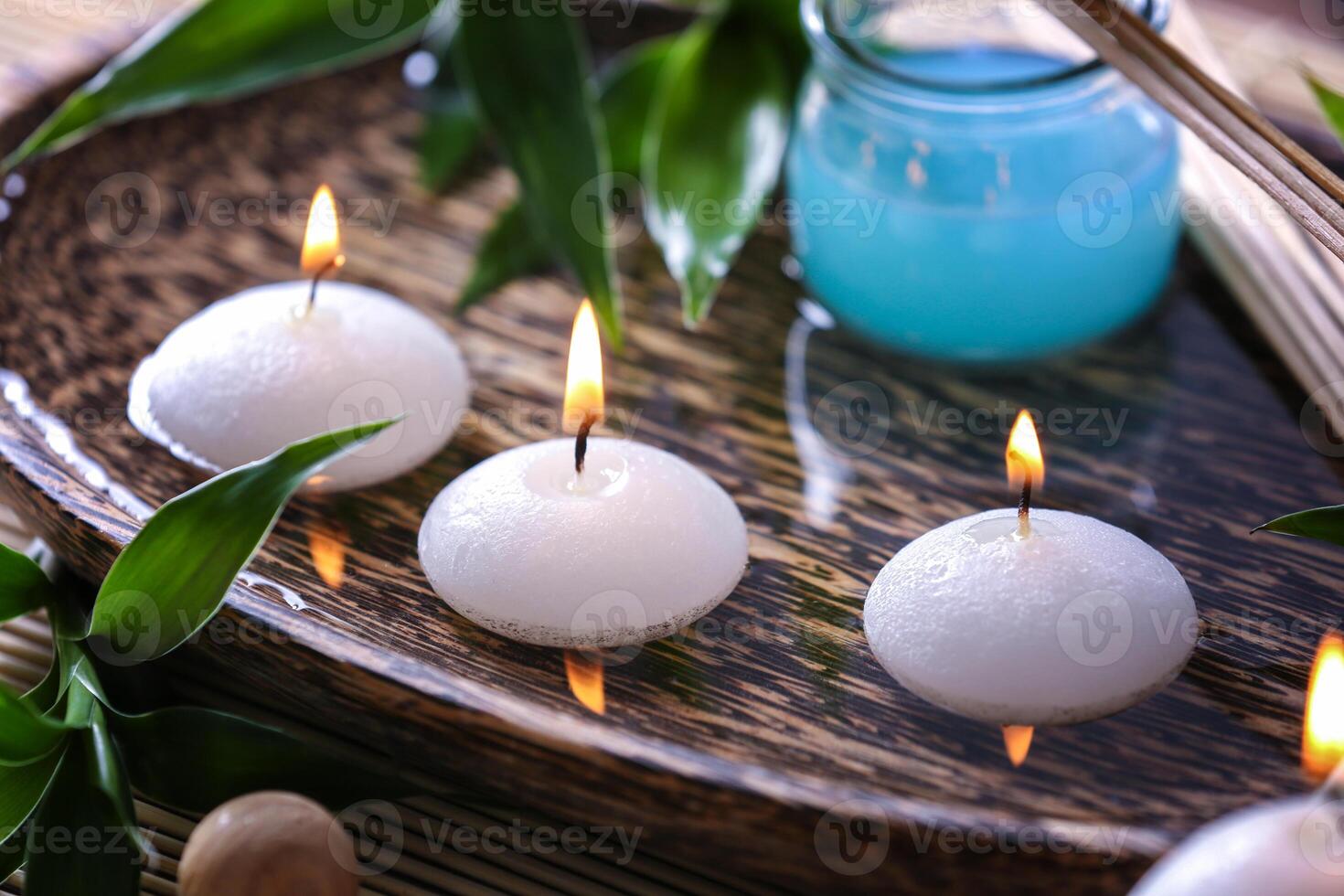 Spa composition with candles on wooden plate photo