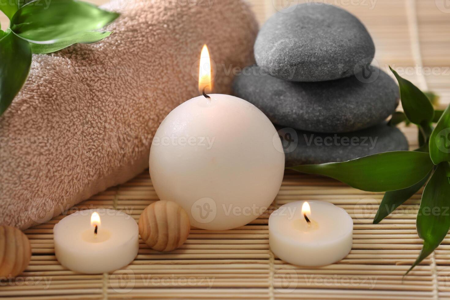 Spa stones, towel and candles, closeup photo