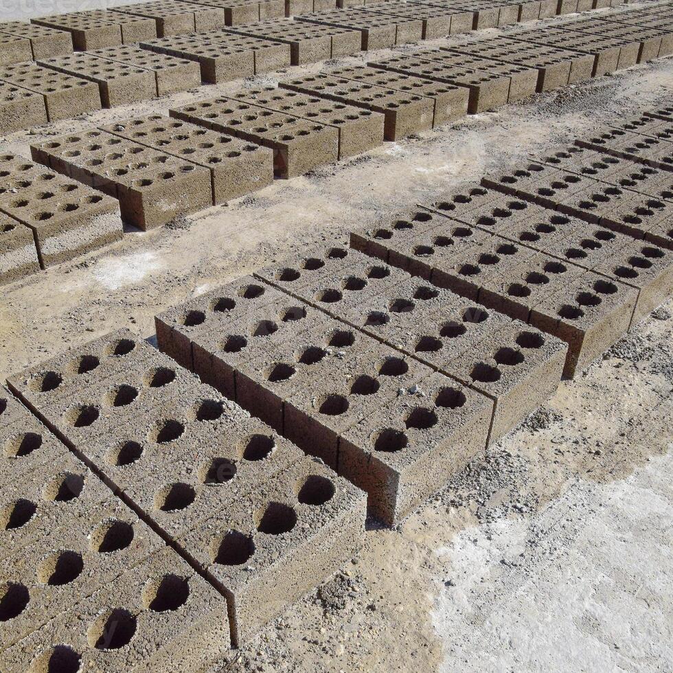 Cinder blocks lie on the ground and dried. on cinder block production plant. photo