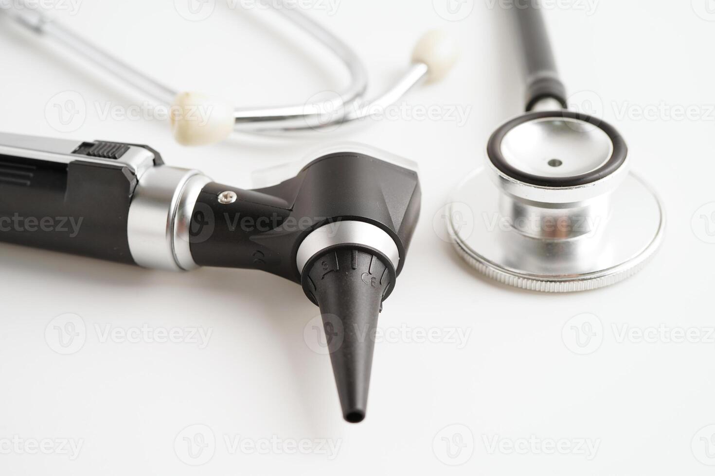 Otoscope isolated on white background for otolaryngologist or ENT physician doctor examining senior patient ear, hearing loss problem. photo