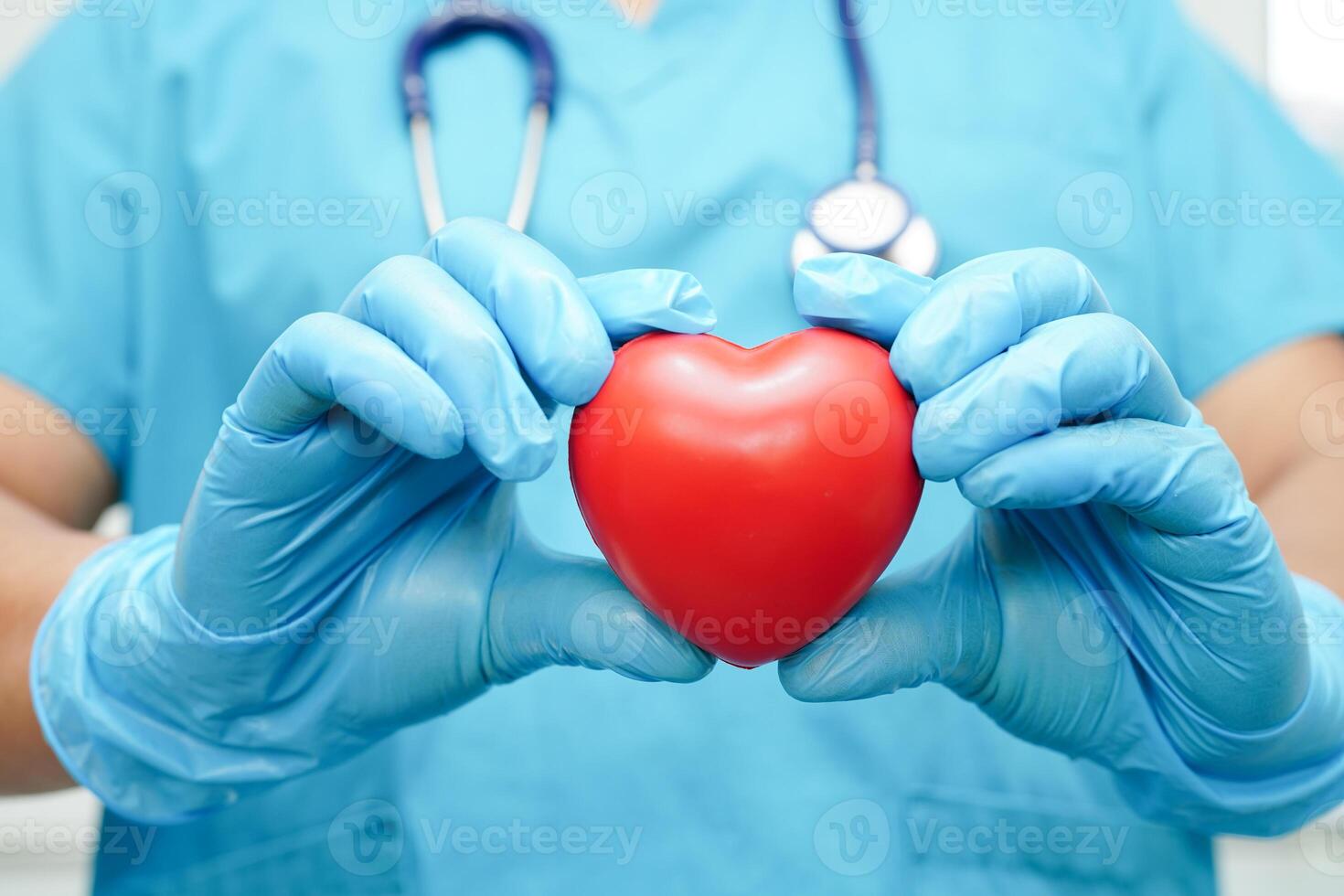 Asian woman doctor holding red heart for health in hospital. photo