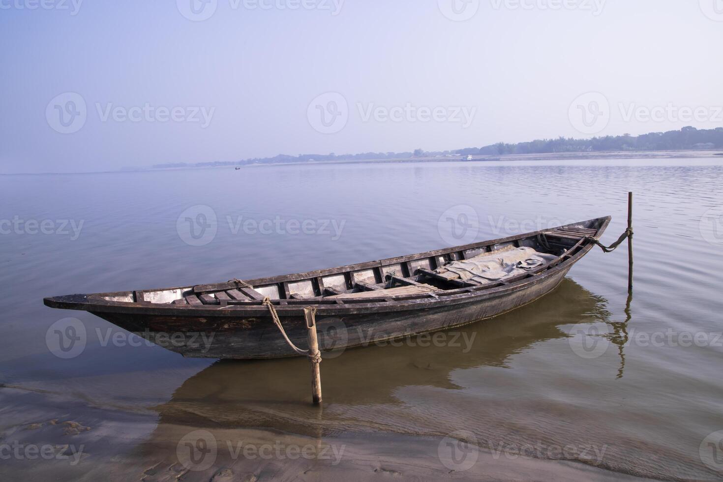 Landscape View of a wooden  boat on the bank of the Padma river in Bangladesh photo