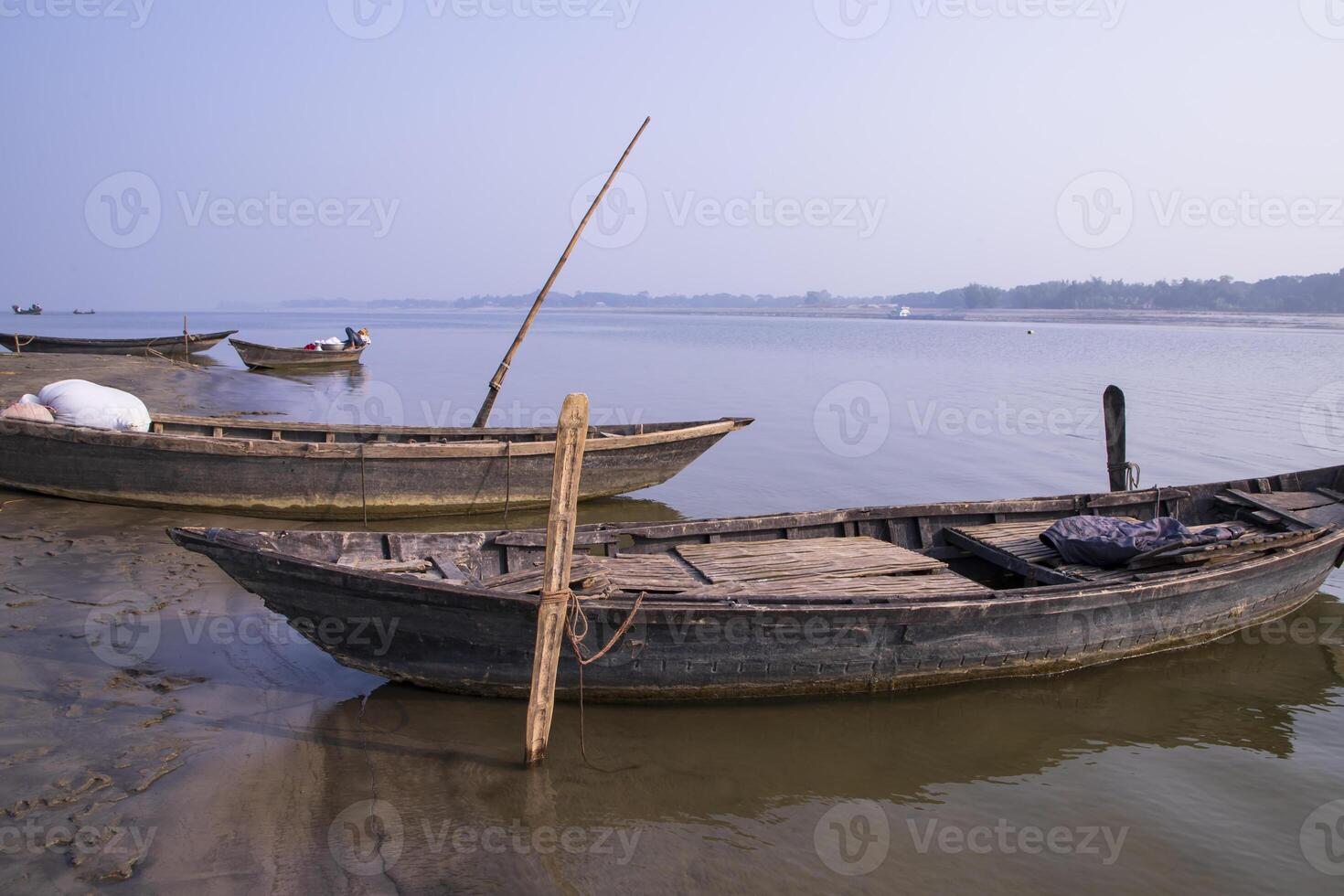 landscape view of Some wooden fishing boats on the shore of the Padma river in Bangladesh photo