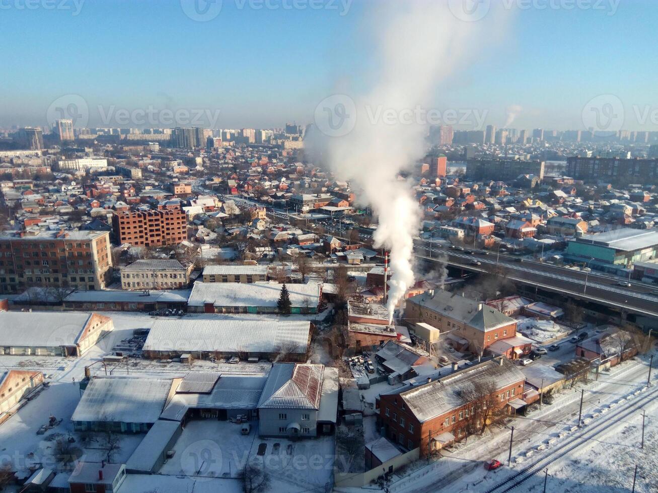 Winter town. Frosty sunny day in the city. Snow on the streets and smoke from the boiler rises. Frost and sun, a wonderful day photo