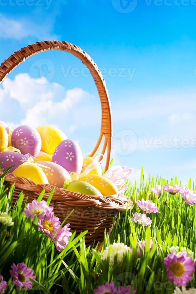 decorated easter eggs in the grass with flower photo