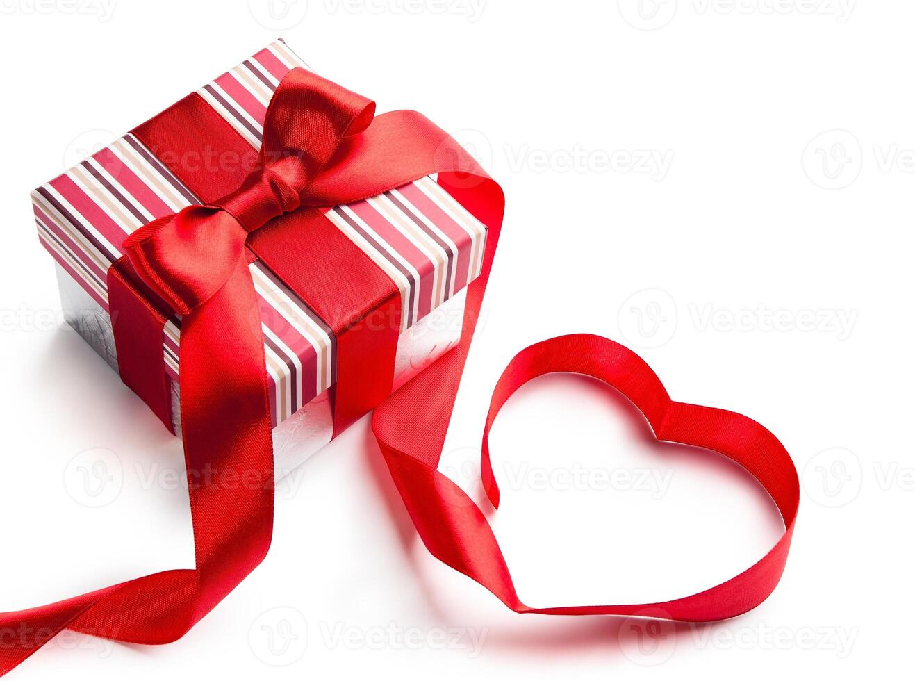 Art gift box with red ribbon in heart shape isolated on white background photo