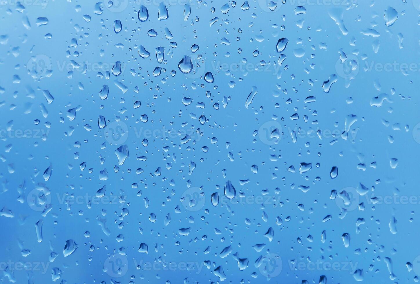 Water drops closeup on glass, natural background photo