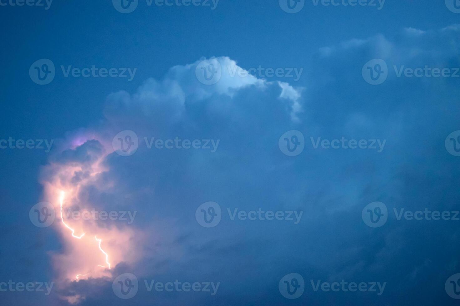 Lightnings in storm clouds. Peals of a thunder and the sparkling lightnings in clouds photo