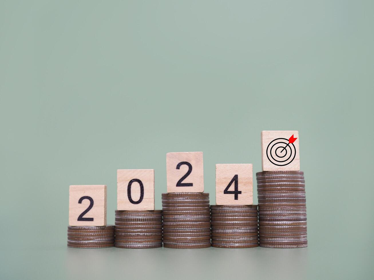 Wooden block with number 2024 on stack of coins. The concept of saving money for business achievement goal, Financial, Investment and Business growing in new year 2024. photo