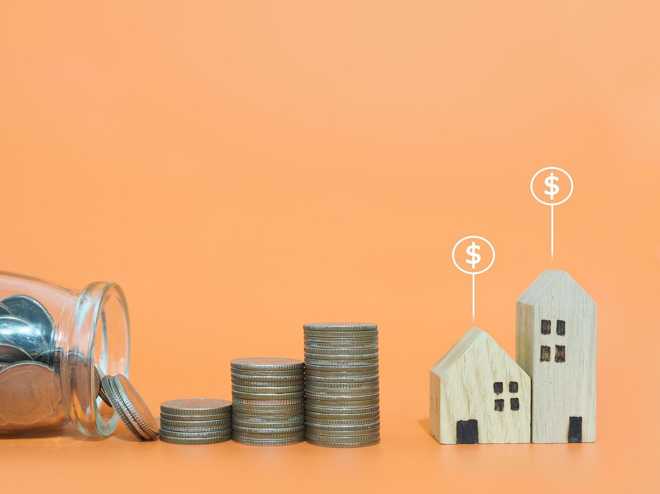 Miniature house with Dollar coin icons and stack of coins. The concept of price of house, Property investment, House mortgage, Real estate photo