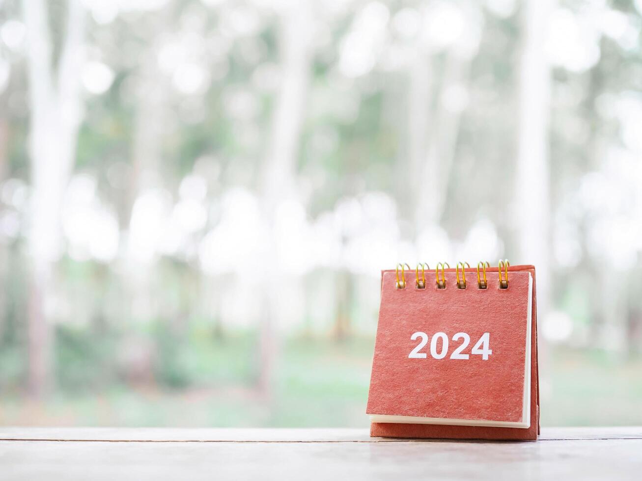 Close up 2024 desk calendar on the table with copy space. Resolution, Goal, Action, Planning, and manage to success business. photo