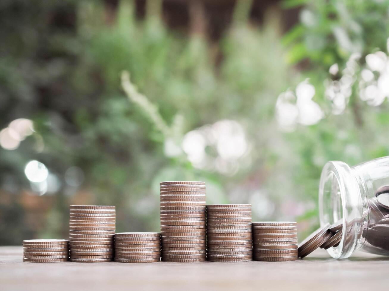 Glass bottle and stack of coins.The concept of save money for prepare in the future photo