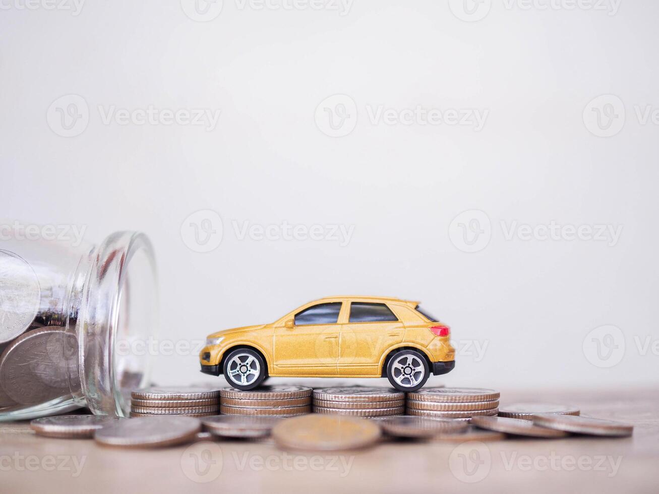 Toy cars on stack of coins. The concept of saving money and manage to success transport business photo