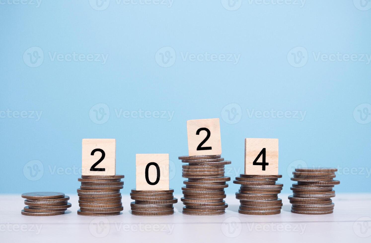 Wooden block with number 2024 on stack of coins. The concept of saving money for business achievement goal, Financial, Investment and Business growing in new year 2024. photo