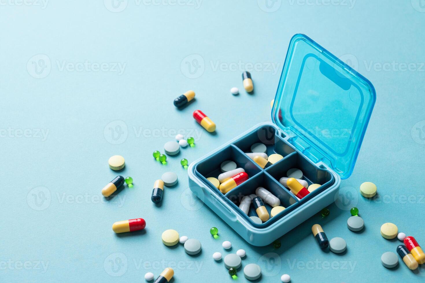 composition with pill box and pills on color background photo