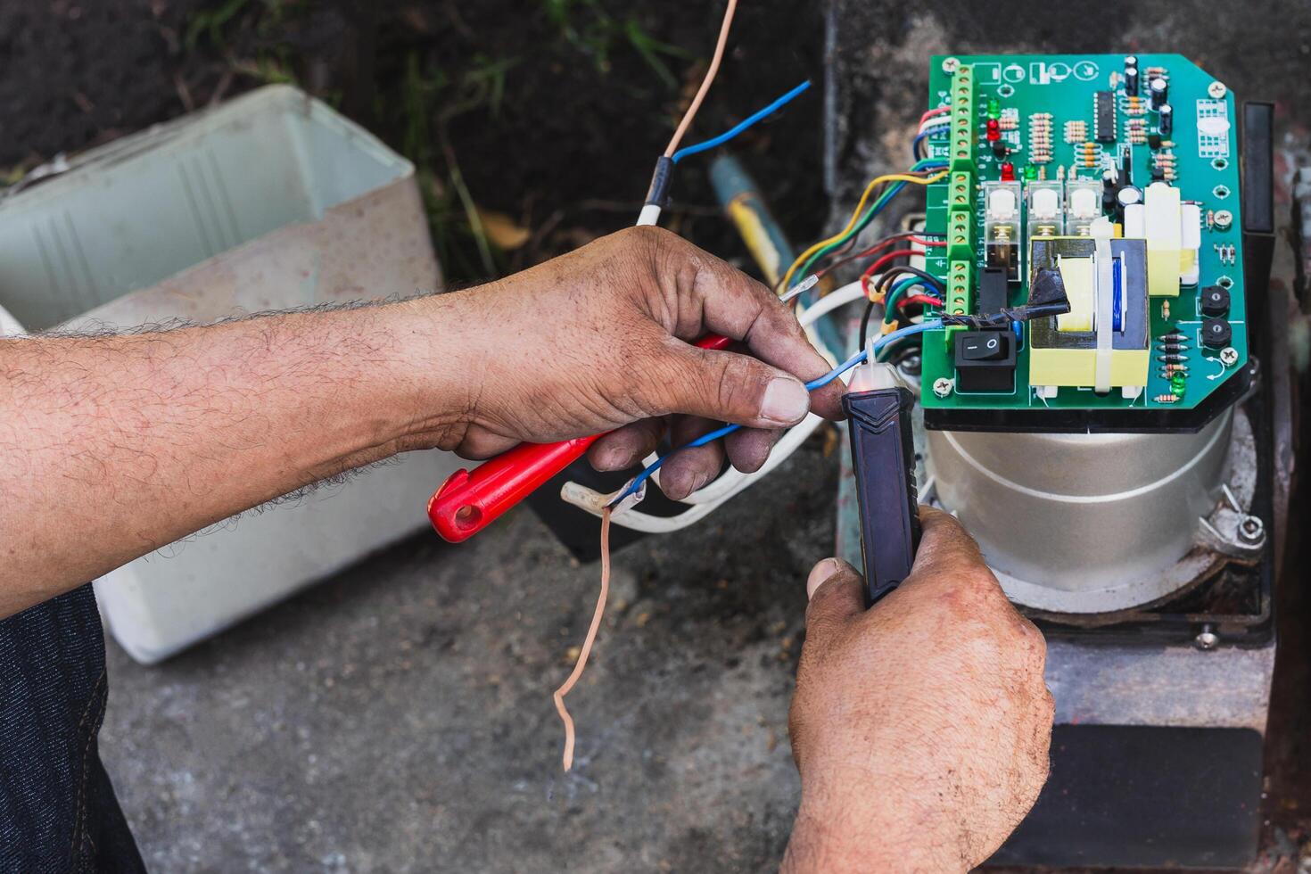 Electrical engineer checking circuit board at home. photo