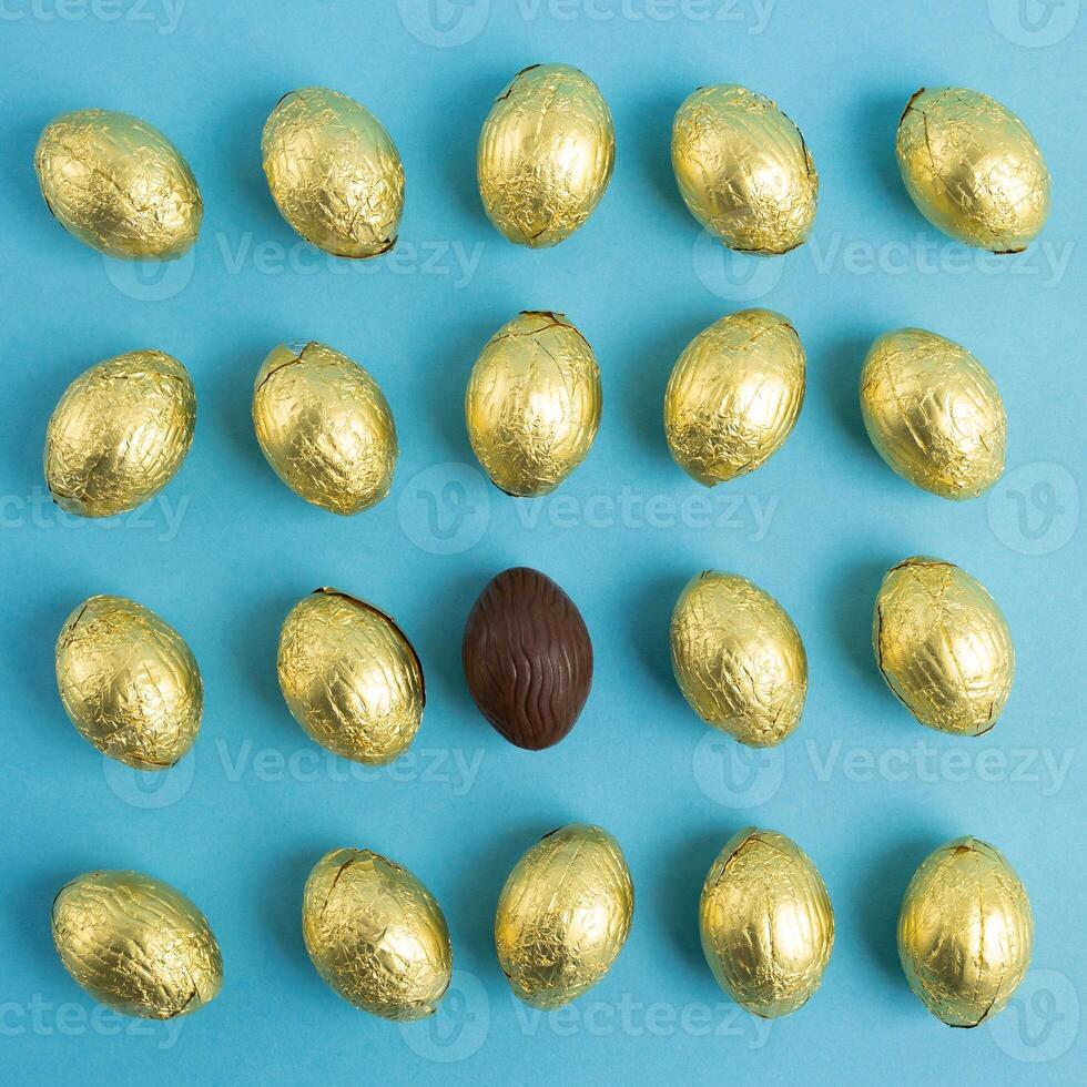 Top view of Chocolate Easter eggs on blue background photo