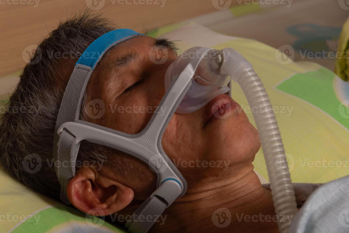 Elderly man using medical CPAP machine photo