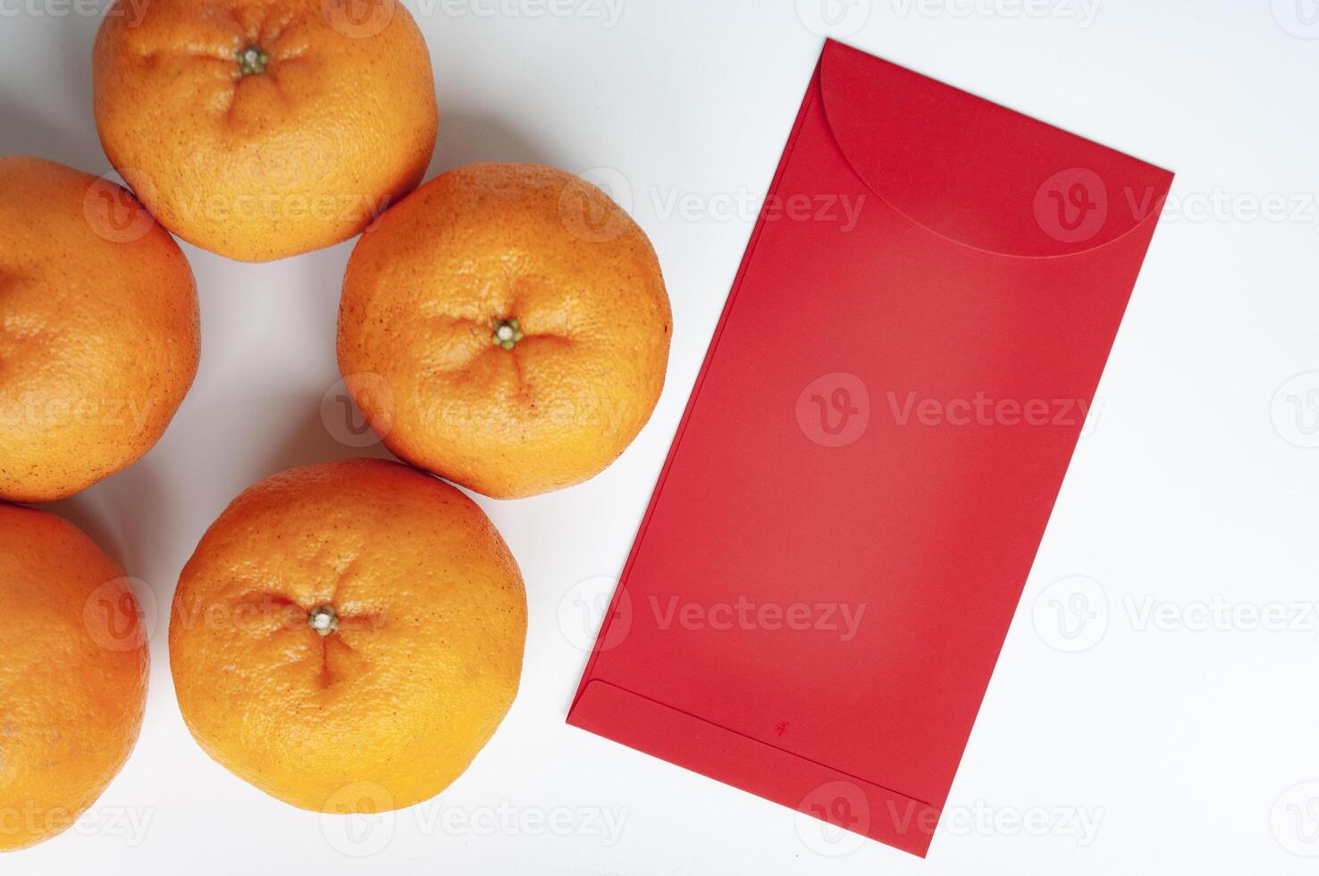 Chinese New Year red envelope and Mandarin oranges with customizable space for text or greetings. Copy space photo