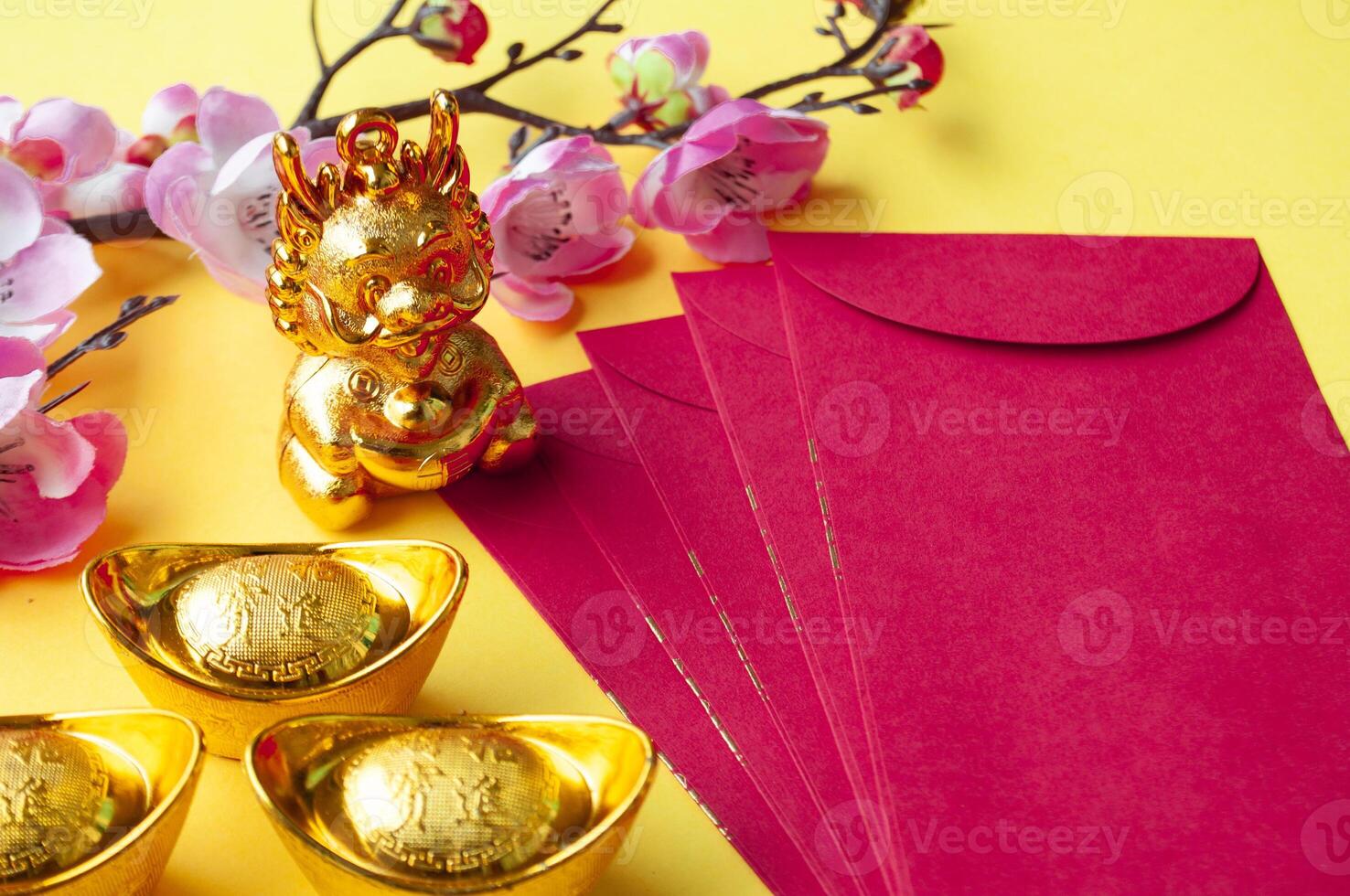 Top view of Chinese New Year red packet, cherry blossom and golden ingots decoration. Copy space. photo