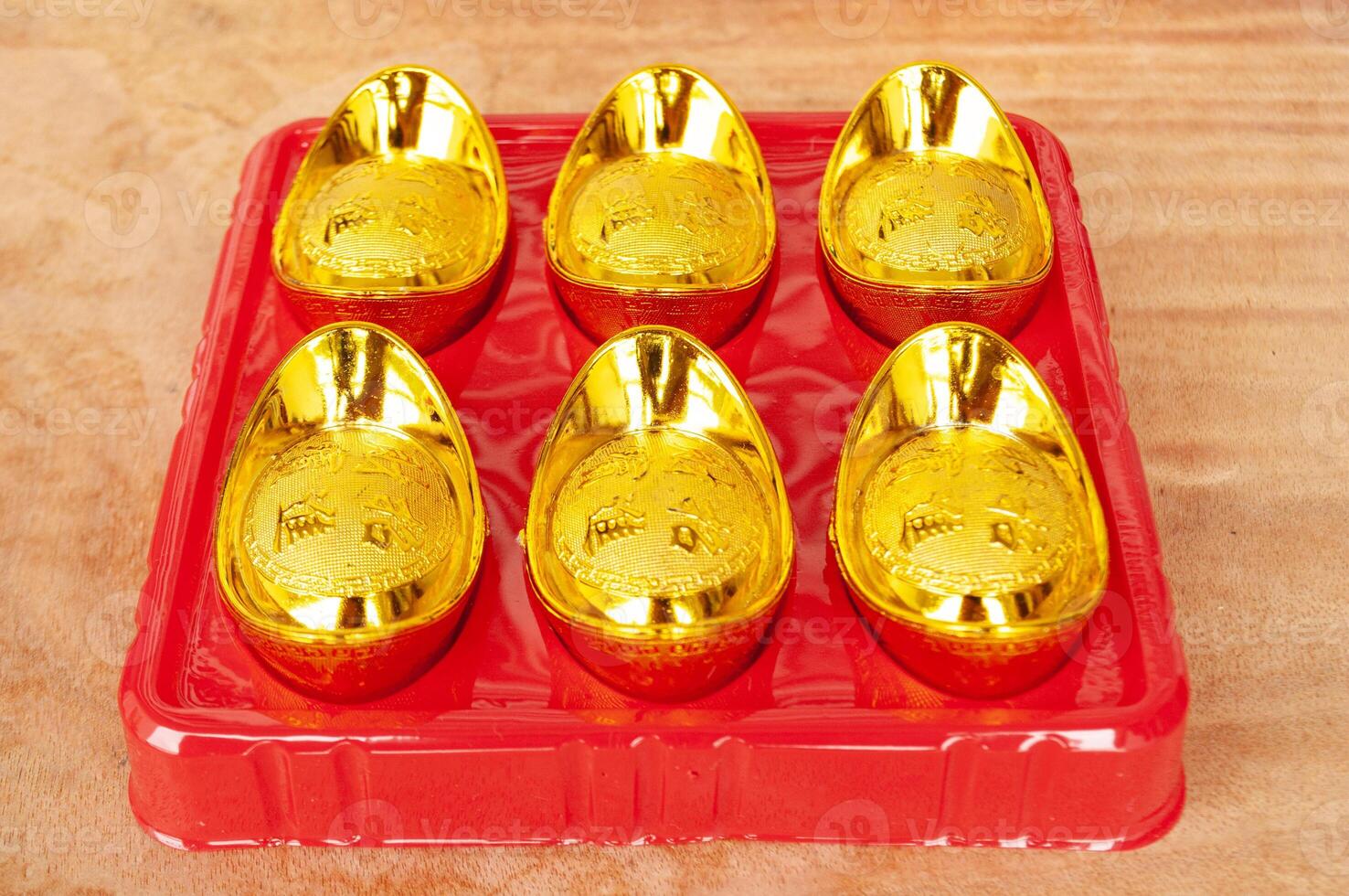 Golden ingots on wooden table. Wealth and abundance concept. photo