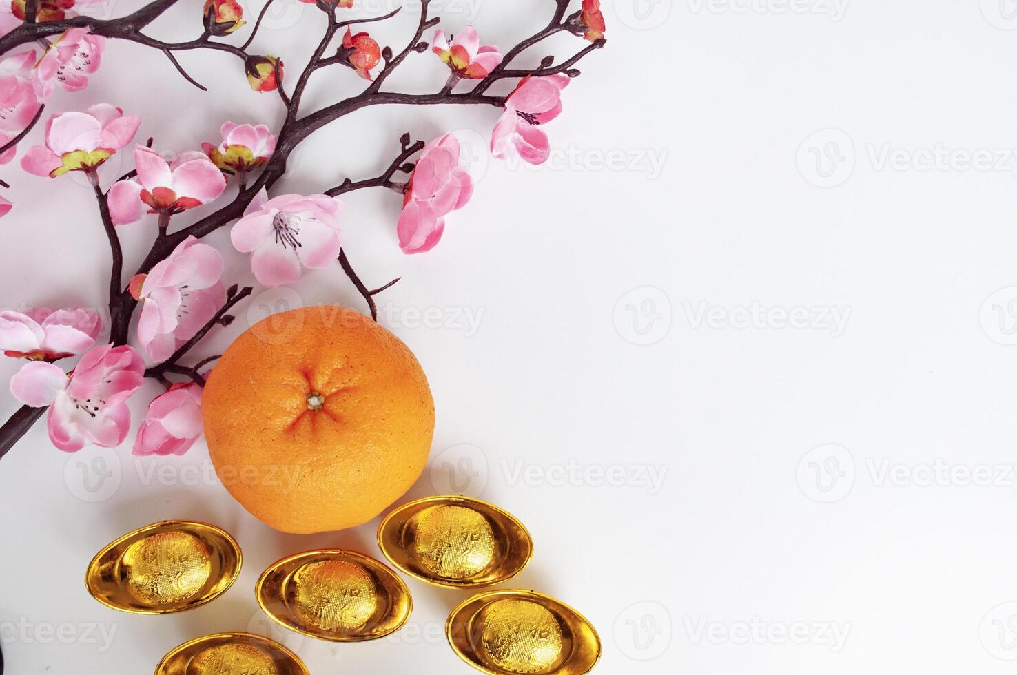Top view of Mandarin oranges and golden ingot with customizable space for text or greetings. Chinese New Year concept photo
