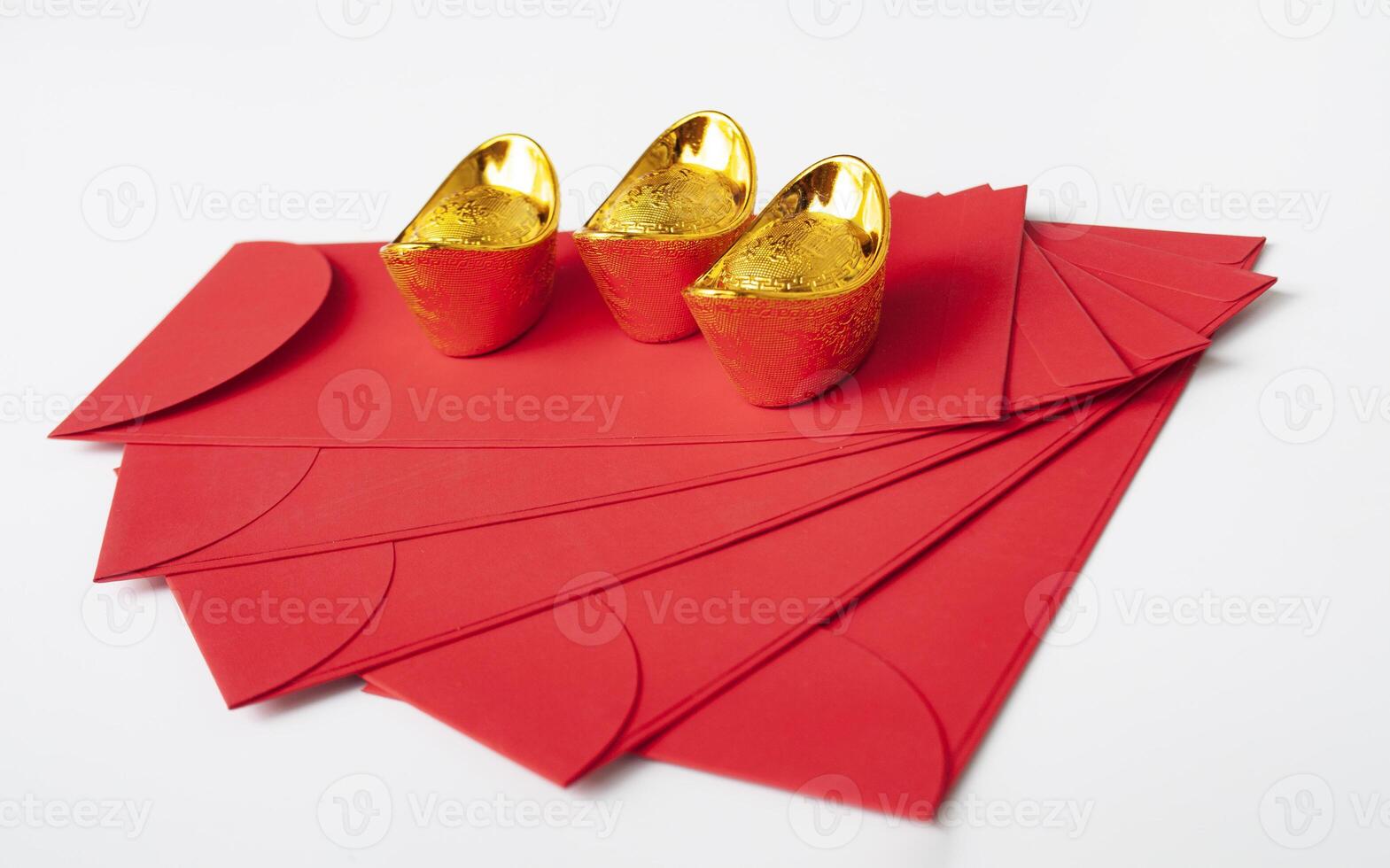 Chinese New Year red packet and golden ingot on white cover. Chinese New Year celebration concept. photo