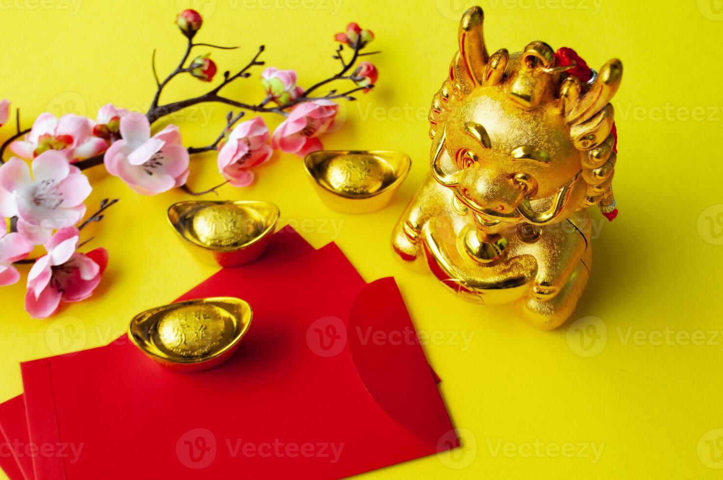 Top view of Chinese New Year red packet and golden ingot. Chinese New Year celebration concept photo