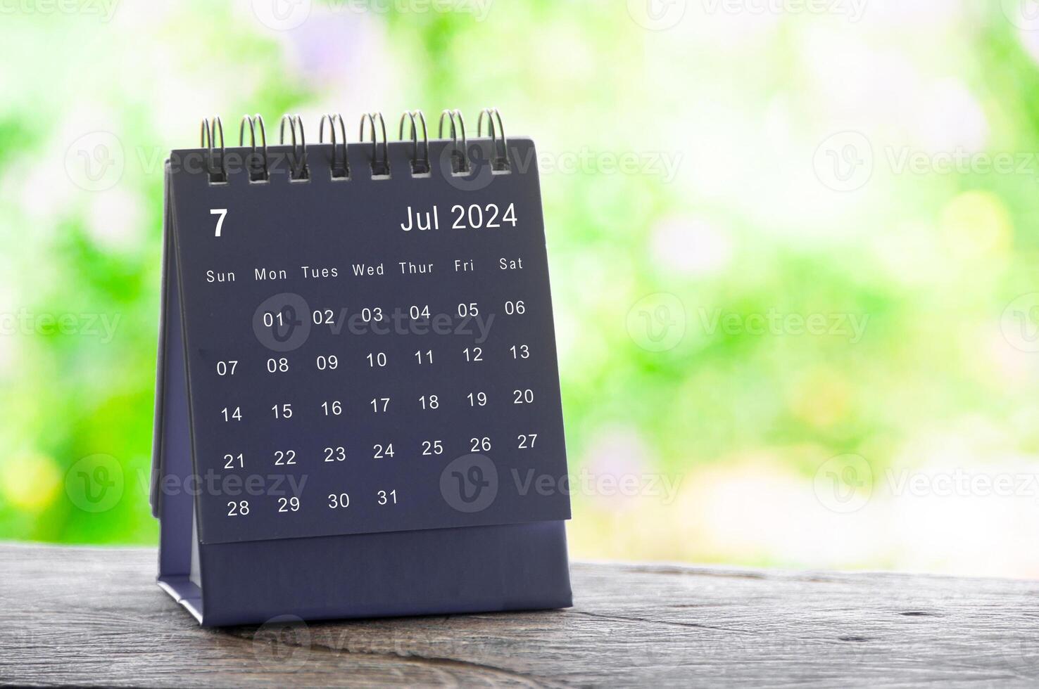 July 2024 table calendar with nature background. Calendar and month concept photo